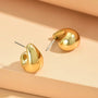 Pair of gold-colored teardrop earrings with a curved design