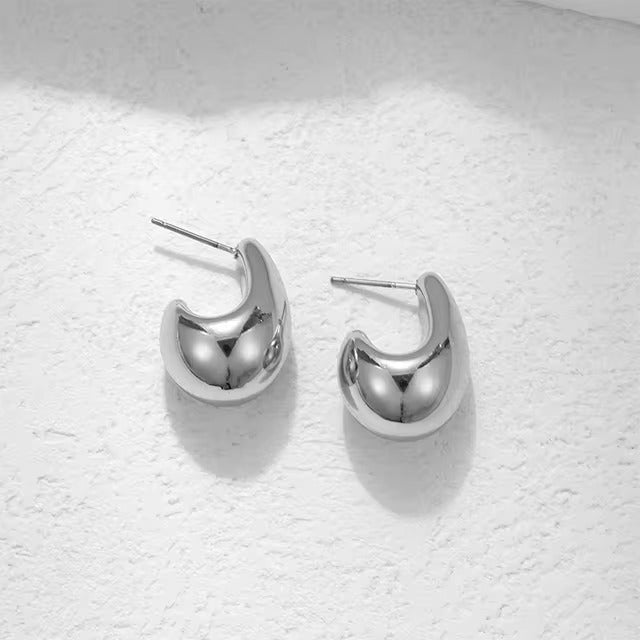 Close-up of nickel-free silver hoop earrings with a smooth finish