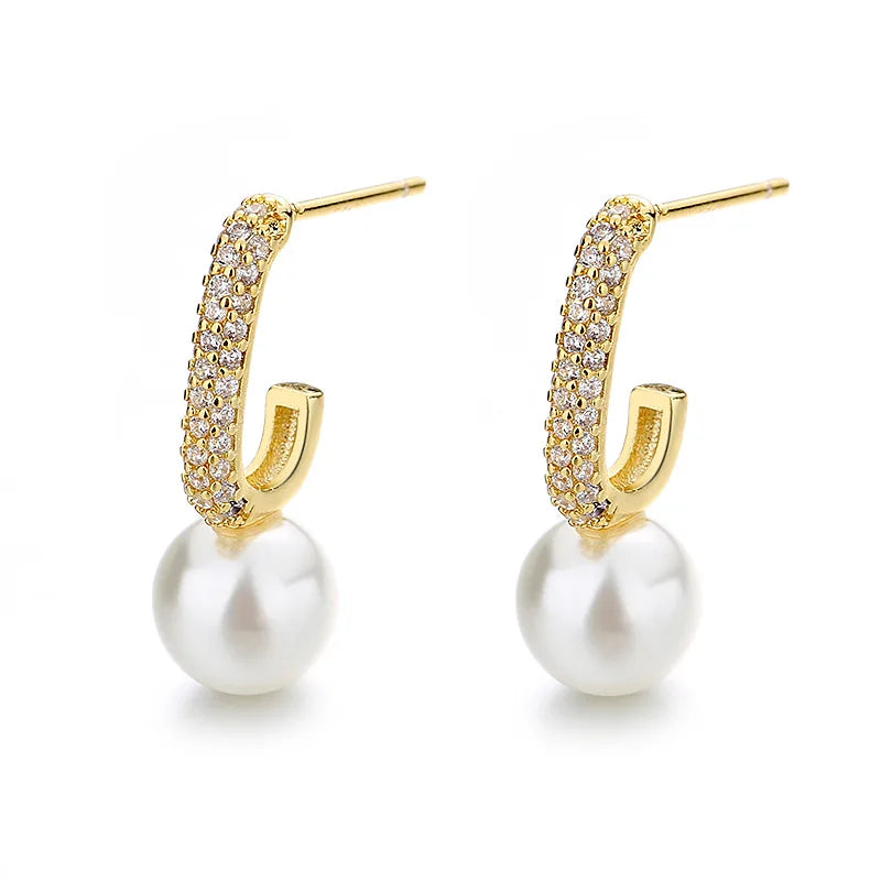 A pair of boho-inspired pearl drop earrings with crystal accents.