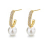 A pair of boho-inspired pearl drop earrings with crystal accents.