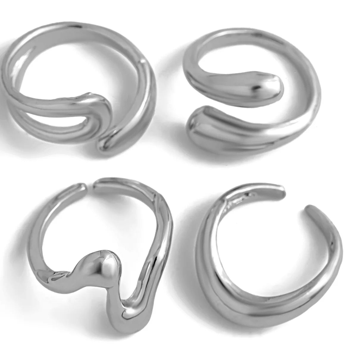 A set of four gold statement rings with a unique wavy shape.