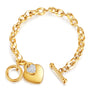 Close-up of a gold-colored bracelet with a heart-shaped pendant