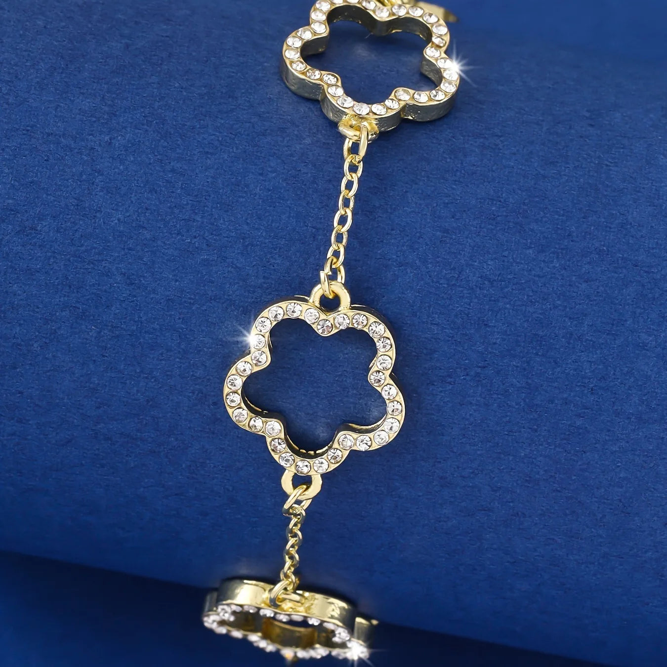 A boho-inspired gold bracelet with flower charms and crystals.