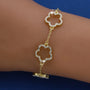 A dainty gold bracelet with flower charms and sparkling crystals.