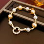 A luxury bracelet with white and golden south sea pearls and a sparkling crystal clasp.