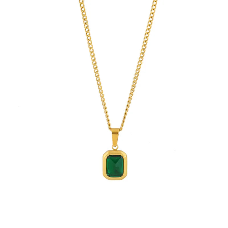 A gold chain necklace with a square emerald pendant.

