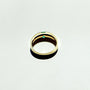 A minimalist gold band with a single square emerald.