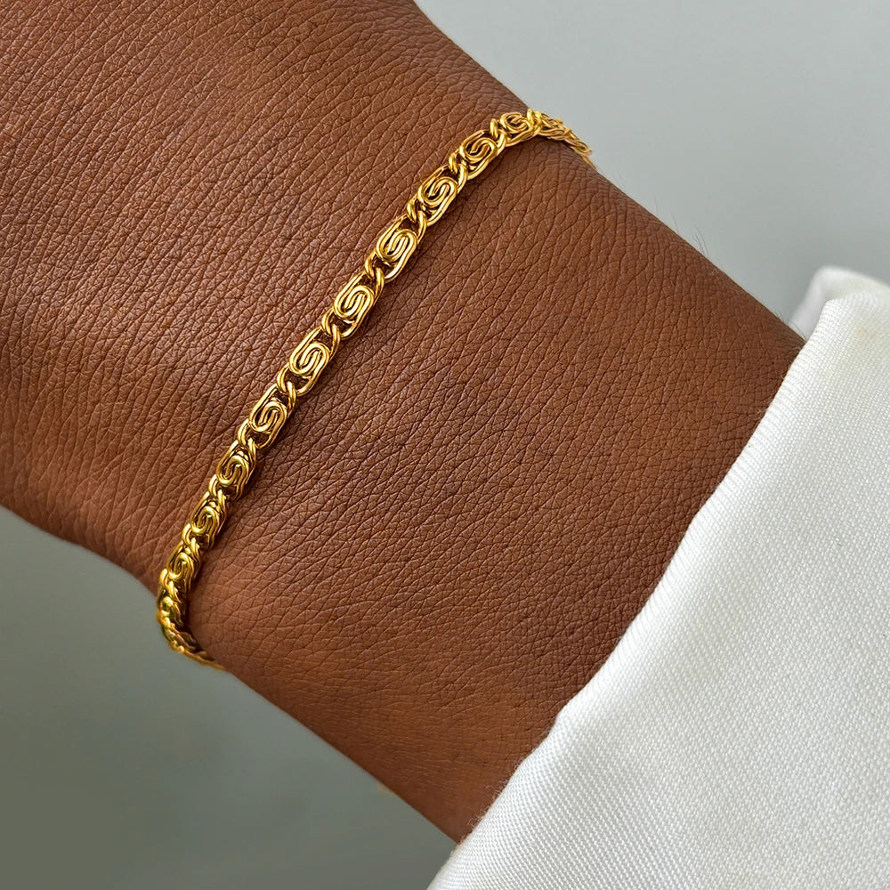 A minimalist gold anklet with a delicate chain link design.