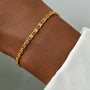 A minimalist gold anklet with a delicate chain link design.