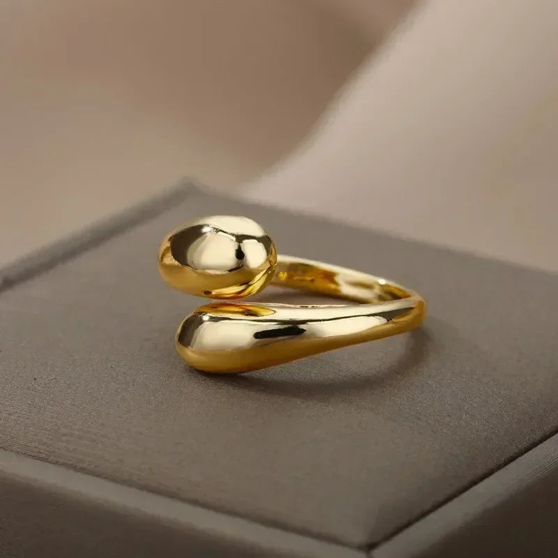 A modern gold ring with a simple, organic design.