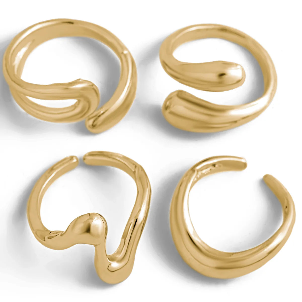 A set of four gold rings with a boho-inspired wavy design.