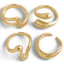 A set of four gold rings with a boho-inspired wavy design.